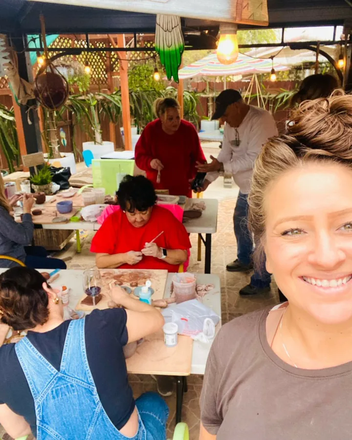 Jazmin in the pottery studio with finished work